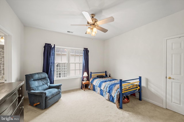 carpeted bedroom with baseboards, ceiling fan, and visible vents
