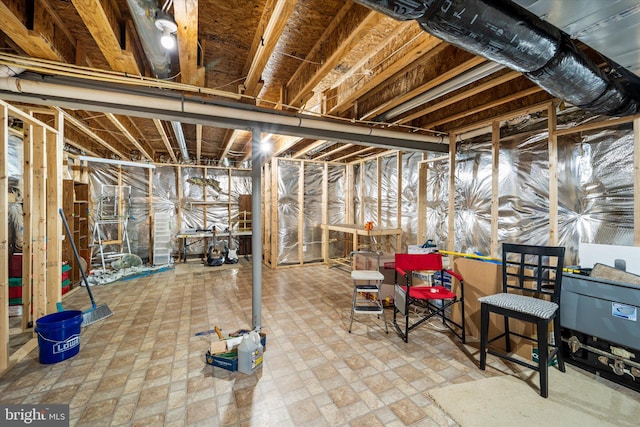 unfinished basement featuring brick floor
