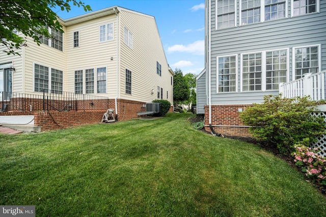 view of home's exterior with a yard and central air condition unit