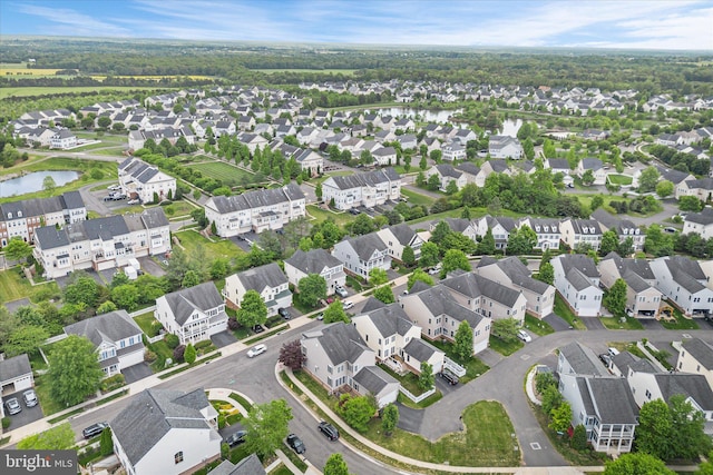 birds eye view of property featuring a water view and a residential view