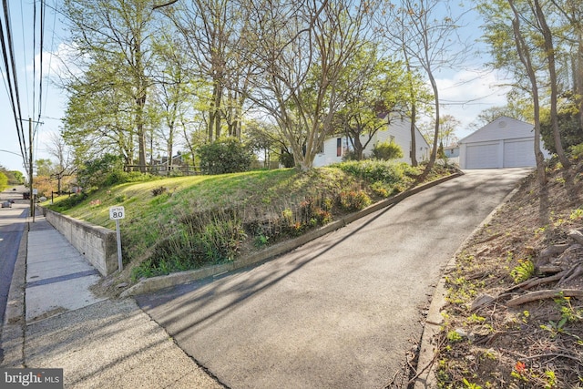 view of street featuring aphalt driveway