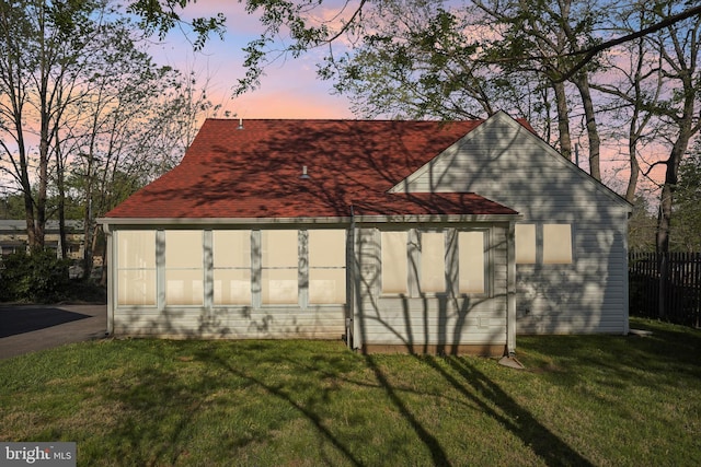 view of side of property featuring a yard and fence