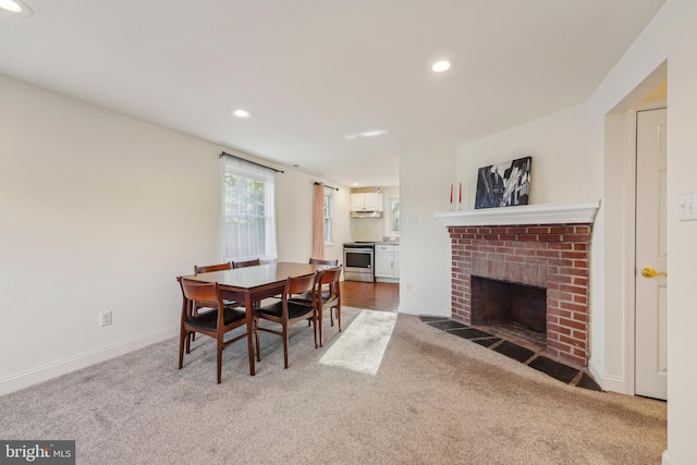 dining space featuring recessed lighting, baseboards, carpet, and a fireplace
