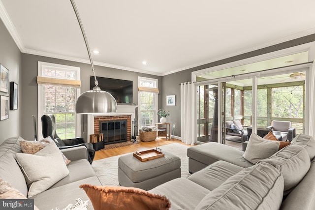 living area featuring wood finished floors, crown molding, a fireplace, recessed lighting, and baseboards