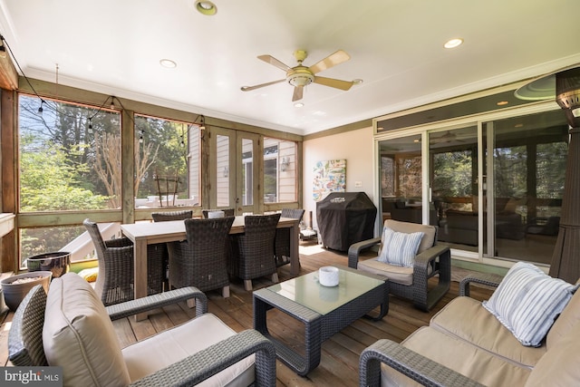 sunroom featuring ceiling fan, outdoor lounge area, outdoor dining space, and french doors