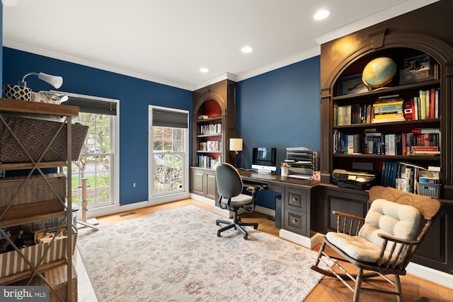 office area featuring wood finished floors, ornamental molding, recessed lighting, baseboards, and built in shelves