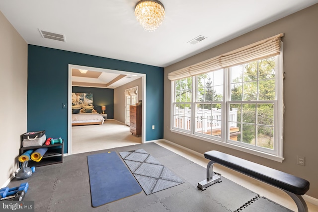 workout room with baseboards, carpet floors, and a chandelier