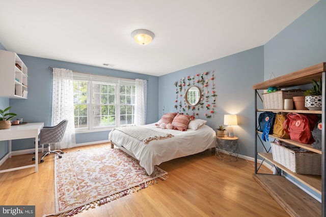 bedroom featuring wood finished floors and baseboards