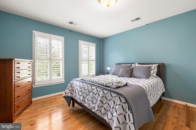 bedroom with light wood-style floors and baseboards