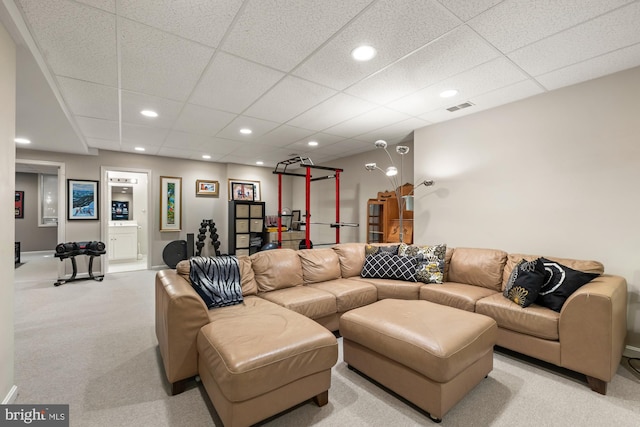 living area featuring light colored carpet, recessed lighting, and a paneled ceiling