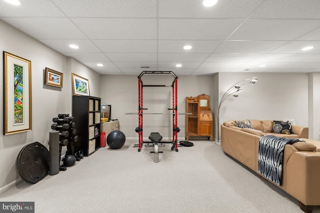 exercise area featuring carpet flooring, recessed lighting, a paneled ceiling, and baseboards
