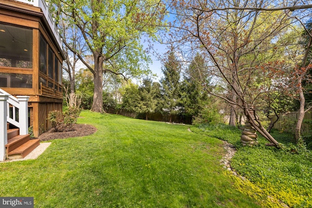 view of yard featuring a sunroom