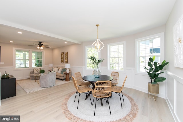 dining room with recessed lighting, a decorative wall, light wood-style floors, a wainscoted wall, and ceiling fan