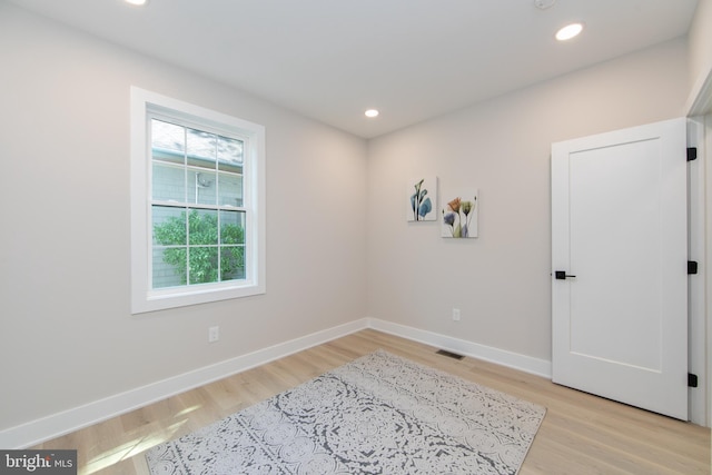 unfurnished room with visible vents, recessed lighting, light wood finished floors, and baseboards
