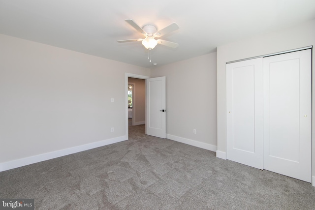 unfurnished bedroom featuring a closet, baseboards, a ceiling fan, and carpet floors