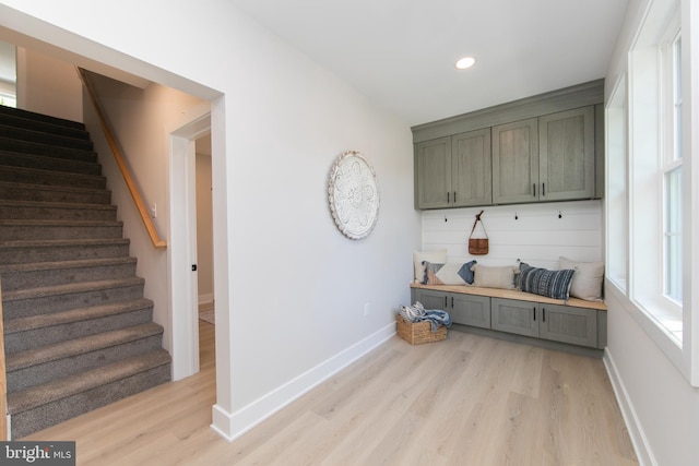 mudroom featuring recessed lighting, baseboards, and light wood-style floors