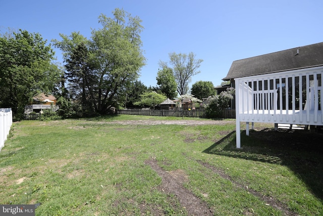 view of yard featuring a deck and fence