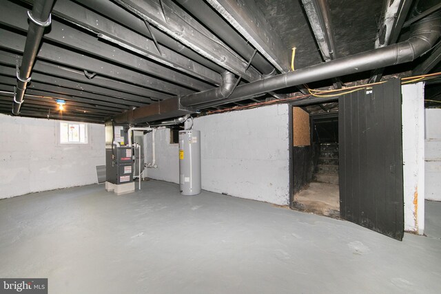 below grade area with heating unit and electric water heater