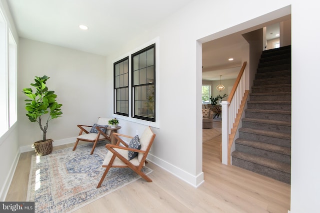 sitting room featuring baseboards, stairway, wood finished floors, and recessed lighting