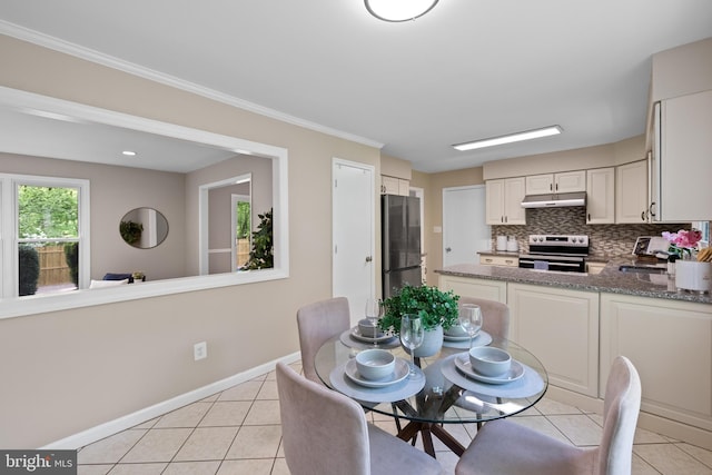 dining area featuring light tile patterned floors and baseboards