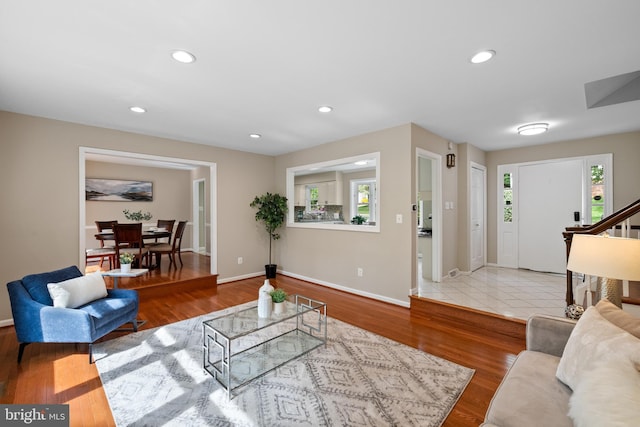 living room featuring a wealth of natural light, recessed lighting, and baseboards