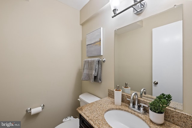 half bathroom featuring toilet and vanity