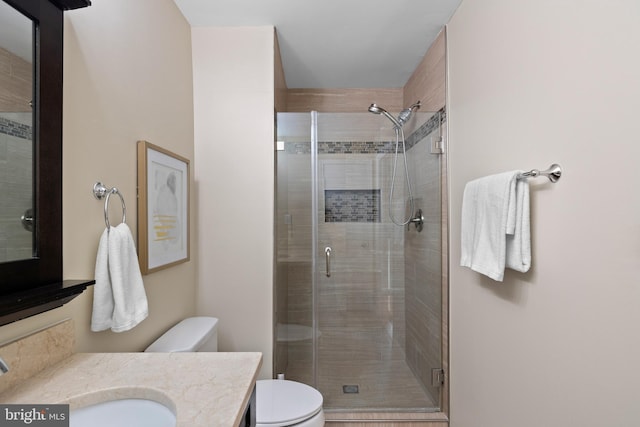 full bath with a shower stall, toilet, and vanity