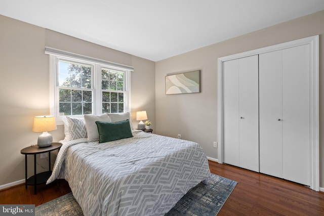 bedroom featuring a closet, wood finished floors, and baseboards