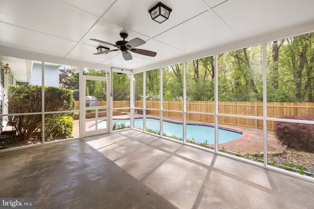 unfurnished sunroom with a ceiling fan