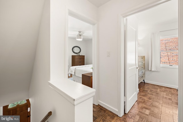 hall featuring baseboards
