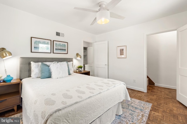 bedroom with a ceiling fan, baseboards, and visible vents