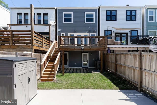 rear view of house featuring stairs and a patio area