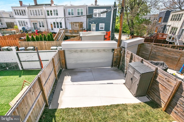 exterior space with a gate, a fenced backyard, and a yard
