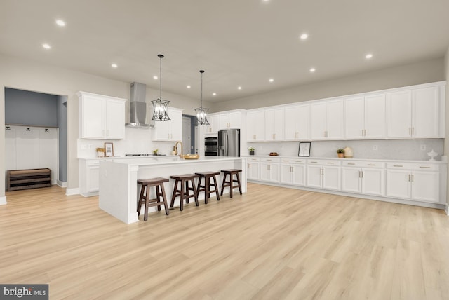 15613 Althea Ln, Gainesville, VA 20155 - kitchen with wall chimney range hood, stainless steel appliances, a breakfast bar area, recessed lighting, and white cabinets