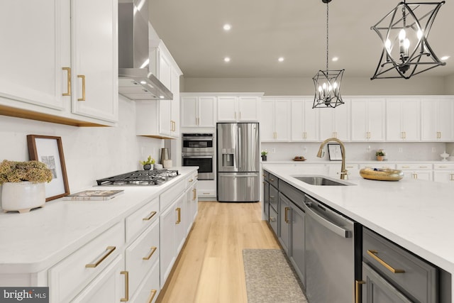 15613 Althea Ln, Gainesville, VA 20155 - kitchen featuring stainless steel appliances, wall chimney exhaust hood, a sink, white cabinets, and gray cabinetry