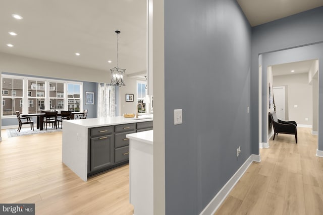 15613 Althea Ln, Gainesville, VA 20155 - hall featuring a sink, recessed lighting, light wood-style floors, a chandelier, and baseboards