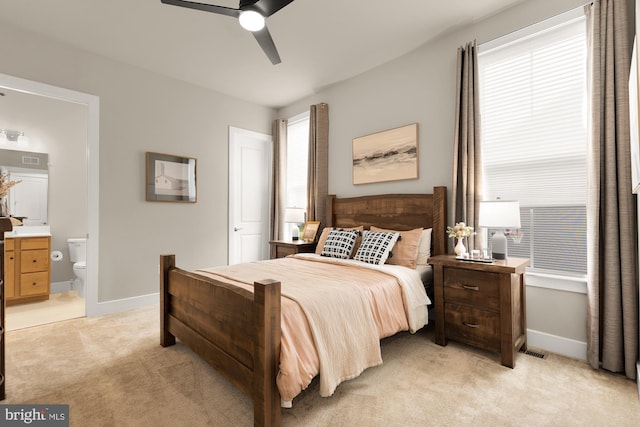 15613 Althea Ln, Gainesville, VA 20155 - bedroom with light carpet, baseboards, ensuite bath, and ceiling fan