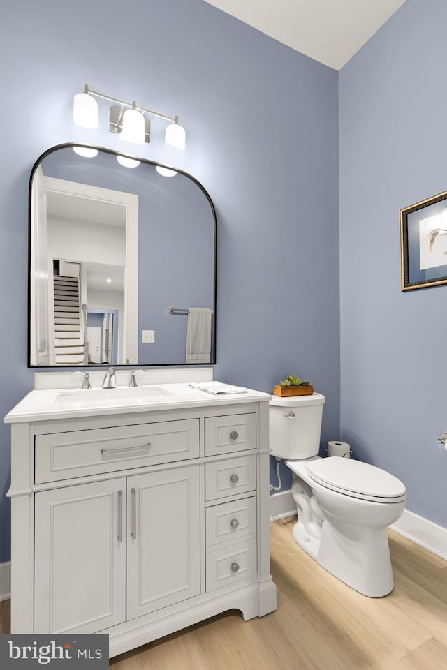 15613 Althea Ln, Gainesville, VA 20155 - bathroom with toilet, baseboards, wood finished floors, and vanity
