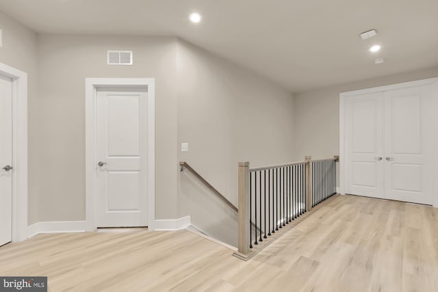 15613 Althea Ln, Gainesville, VA 20155 - hall with an upstairs landing, wood finished floors, recessed lighting, and baseboards