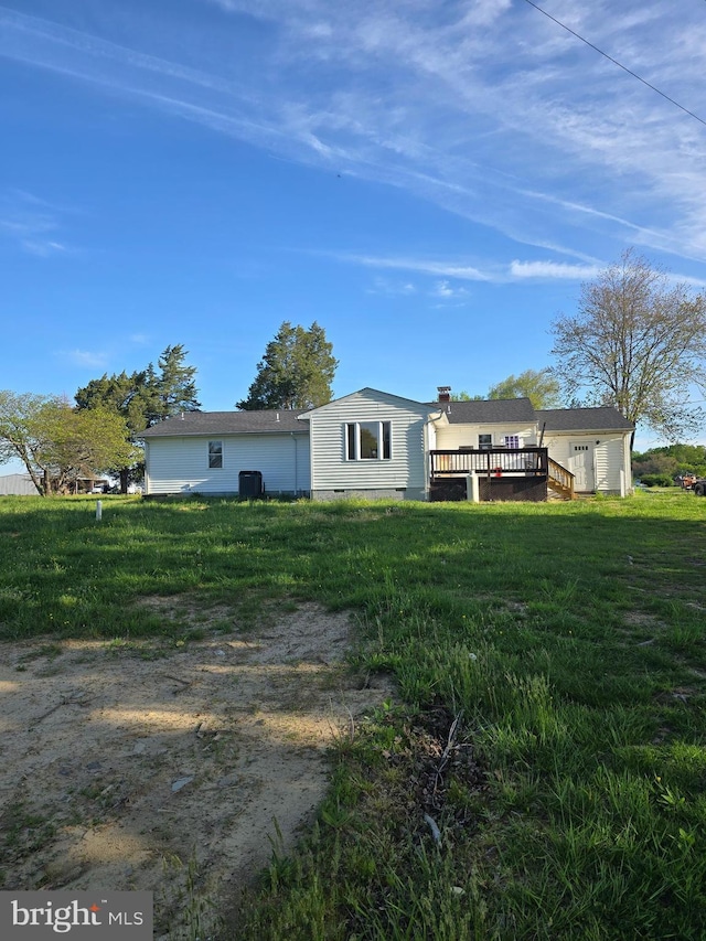 back of house with a wooden deck, a lawn, and crawl space