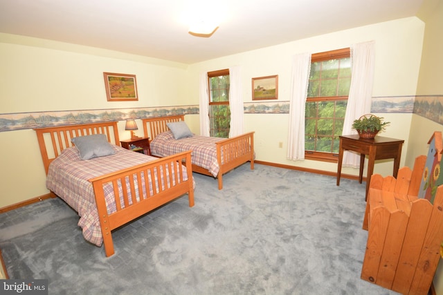 bedroom with baseboards and carpet