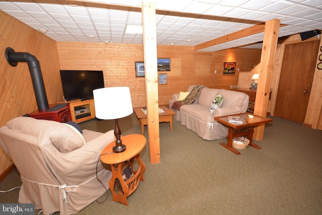 living room with wooden walls and a drop ceiling