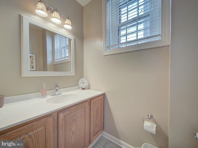 bathroom featuring vanity, tile patterned flooring, and baseboards
