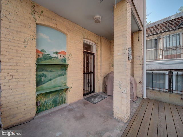 doorway to property featuring brick siding