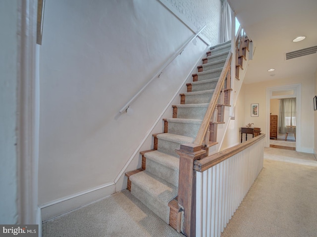 stairs with visible vents, a healthy amount of sunlight, baseboards, recessed lighting, and carpet