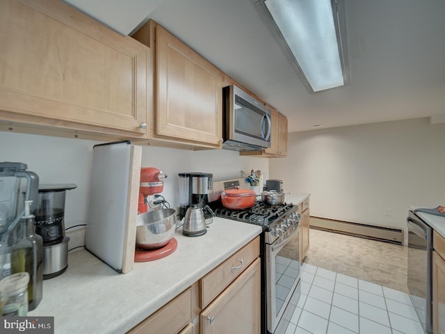 kitchen featuring light countertops, light brown cabinetry, stainless steel appliances, and a baseboard heating unit