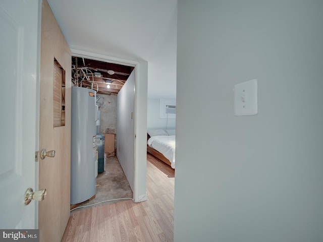 corridor featuring wood finished floors and water heater