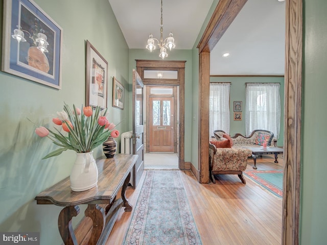foyer entrance with recessed lighting, baseboards, a chandelier, and hardwood / wood-style flooring