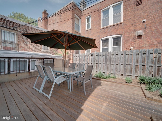 wooden deck with fence and outdoor dining space