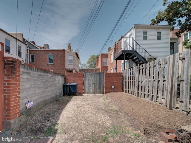 view of yard with a fenced backyard and a gate